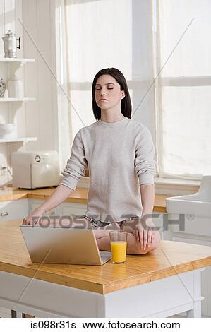 Meditating woman with laptop View Large Photo Image Stock Photograph - Meditating woman with laptop. Fotosearch