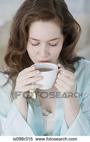 Woman having herbal tea View Large Photo Image Stock Photography - Woman having herbal tea. Fotosearch