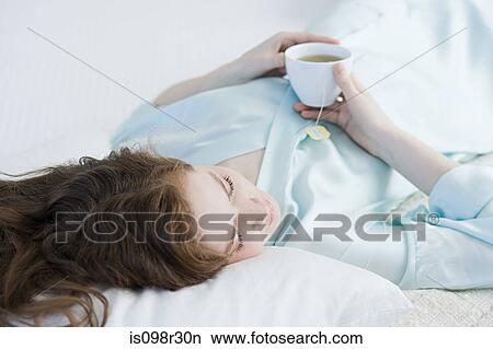 Woman relaxing with tea View Large Photo Image Picture - Woman relaxing with tea. Fotosearch