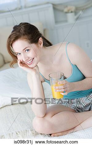 Woman with orange juice View Large Photo Image Stock Image - Woman with orange juice. Fotosearch