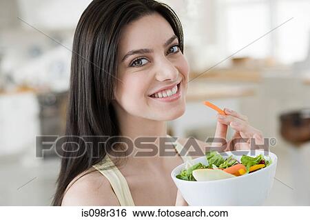 Young woman eating salad View Large Photo Image Stock Photograph - Young woman eating salad. Fotosearch