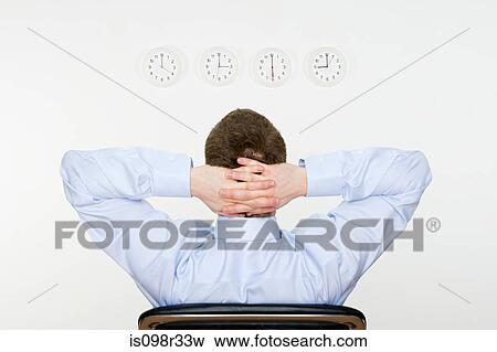 Businessman and wall clocks View Large Photo Image Stock Photo - Businessman and wall clocks. Fotosearch