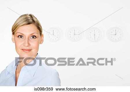Stock Photo - Businesswoman and clocks. Fotosearch