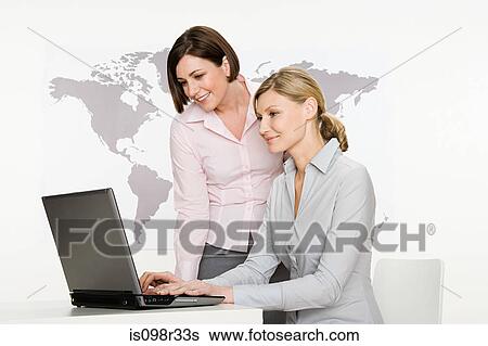 Businesswomen with laptop View Large Photo Image Stock Photograph - Businesswomen with laptop. Fotosearch