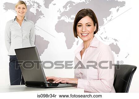 Businesswomen with laptop View Large Photo Image Stock Photography - Businesswomen with laptop. Fotosearch