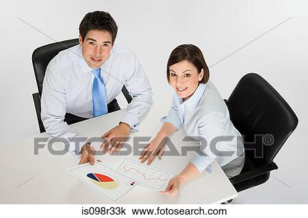Stock Image - Colleagues with chart and graph. Fotosearch