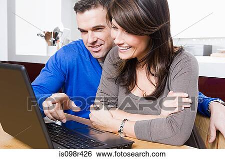 Stock Photograph - Couple with laptop. Fotosearch