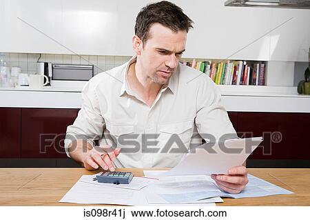 Man doing home finances View Large Photo Image Stock Image - Man doing home finances. Fotosearch