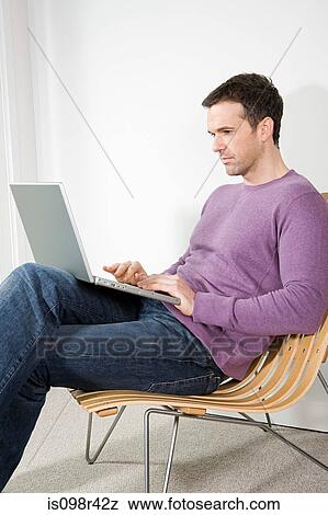 Man using laptop View Large Photo Image Stock Photo - Man using laptop. Fotosearch