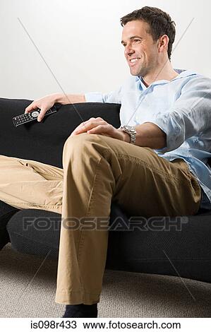 Man watching television View Large Photo Image Stock Image - Man watching television. Fotosearch