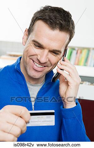 Man with credit card and cellphone View Large Photo Image Stock Photo - Man with credit card and cellphone. Fotosearch