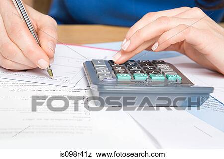 Person with calculator and forms View Large Photo Image Stock Photo - Person with calculator and forms. Fotosearch