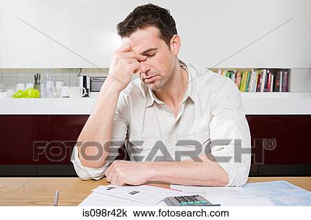 Stock Image - Stressed man with bills. Fotosearch
