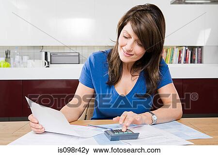 Woman doing home finances View Large Photo Image Stock Photo - Woman doing home finances. Fotosearch