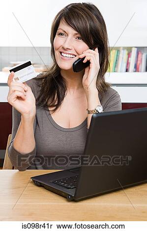 Woman with cellphone credit card and laptop View Large Photo Image Stock Photography - Woman with cellphone credit card and laptop. Fotosearch