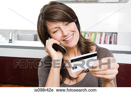 Woman with credit card and cellphone View Large Photo Image Stock Image - Woman with credit card and cellphone. Fotosearch