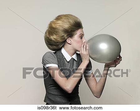 Businesswoman blowing balloon View Large Photo Image Stock Photograph - Businesswoman blowing balloon. Fotosearch