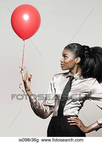 Businesswoman holding balloon View Large Photo Image Stock Image - Businesswoman holding balloon. Fotosearch