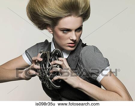 Stock Photograph - Businesswoman holding cable. Fotosearch