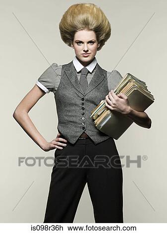 Stock Image - Businesswoman holding files. Fotosearch