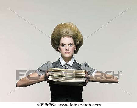Stock Image - Businesswoman holding files. Fotosearch