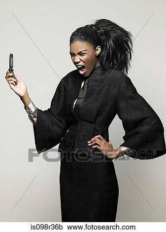 Businesswoman holding mobile phone View Large Photo Image Stock Image - Businesswoman holding mobile phone. Fotosearch
