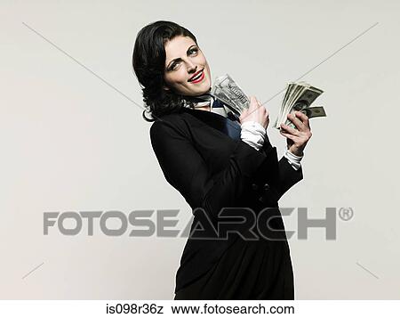 Stock Photo - Businesswoman holding money. Fotosearch