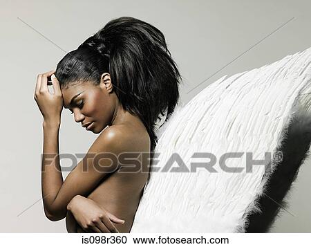 Young woman wearing angel wings View Large Photo Image Stock Image - Young woman wearing angel wings. Fotosearch