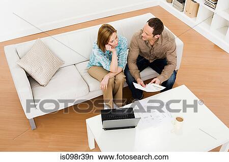 Couple sitting on couch View Large Photo Image Picture - Couple sitting on couch. Fotosearch