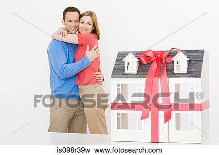 Couple with model house View Large Photo Image Stock Photo - Couple with model house. Fotosearch