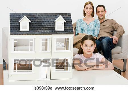 Stock Image - Family with model house. Fotosearch