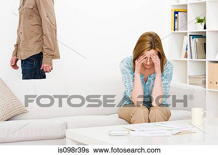 Woman sitting on sofa View Large Photo Image Stock Photograph - Woman sitting on sofa. Fotosearch