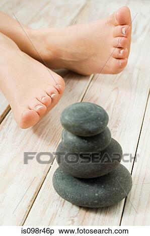 Female feet and stones View Large Photo Image Stock Photography - Female feet and stones. Fotosearch