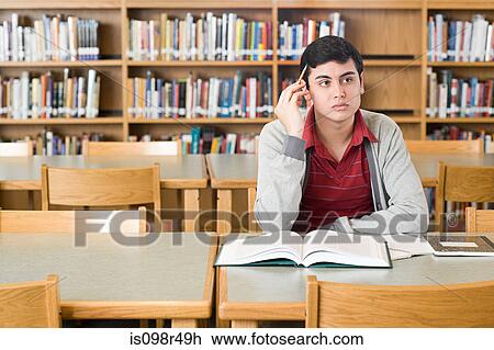 Stock Image - Boy in library. Fotosearch