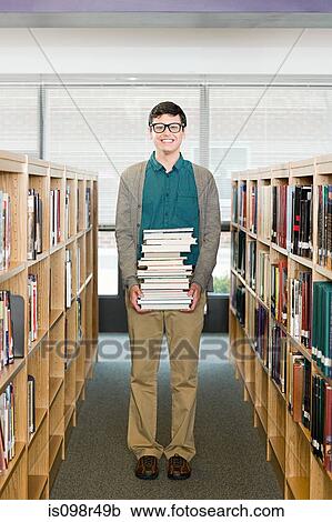 Boy in library with books View Large Photo Image Stock Image - Boy in library with books. Fotosearch