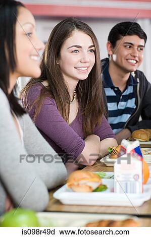 Stock Image - School students having lunch. Fotosearch