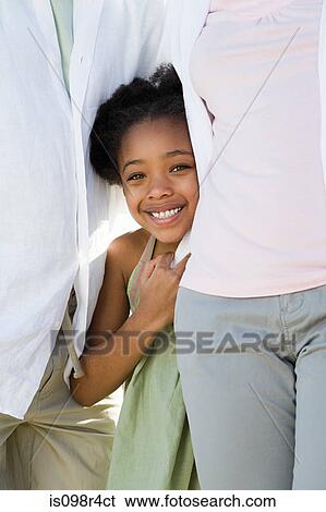 Girl standing between her parents View Large Photo Image Stock Photograph - Girl standing between her parents. Fotosearch