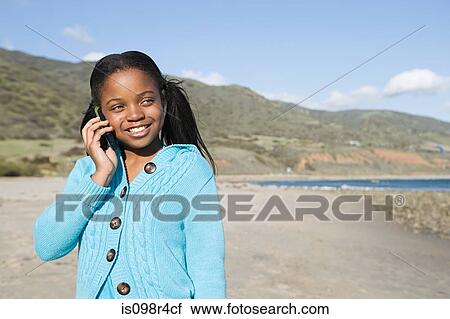 Girl using a cellular telephone View Large Photo Image Stock Image - Girl using a cellular telephone. Fotosearch