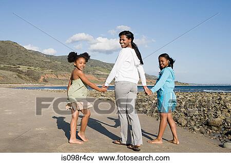 Stock Photo - Mother and daughters holding hands. Fotosearch