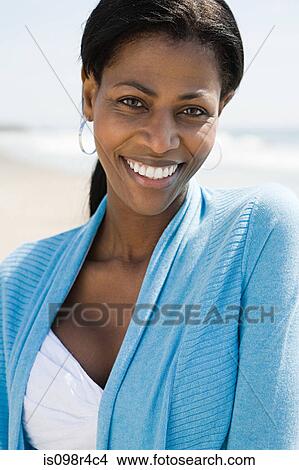 Picture - Smiling woman on a beach. Fotosearch