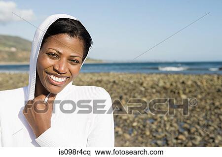 Smiling woman on a shingle beach View Large Photo Image Stock Photography - Smiling woman on a shingle beach. Fotosearch
