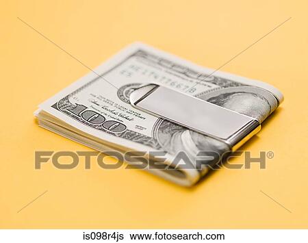 Stock Photograph - One hundred dollar bills in clip. Fotosearch