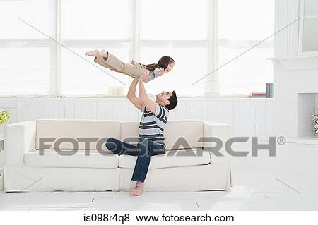 Stock Photo - Father playing with daughter. Fotosearch