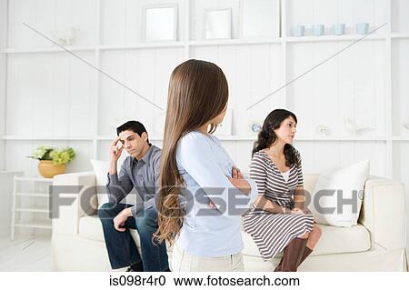 Girl looking at her hostile parents View Large Photo Image Stock Image - Girl looking at her hostile parents. Fotosearch