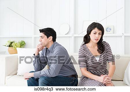 Stock Image - Hostile couple in a living room. Fotosearch