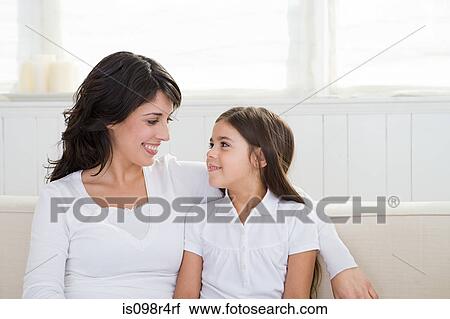 Stock Image - Mother and daughter on a sofa. Fotosearch