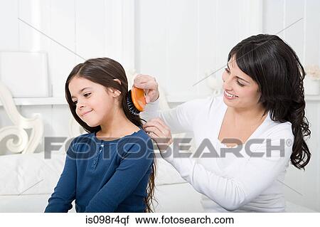 Mother combing daughters hair View Large Photo Image Stock Image - Mother combing daughters hair. Fotosearch