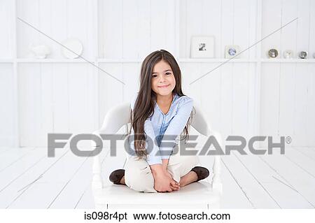 Portrait of a hispanic girl on a chair View Large Photo Image Stock Photograph - Portrait of a hispanic girl on a chair. Fotosearch