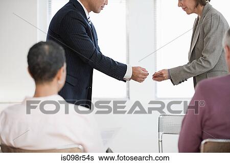 Stock Photograph - Businesspeople exchanging business cards. Fotosearch