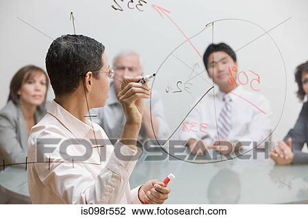 Stock Image - Businesswoman with chart on glass. Fotosearch